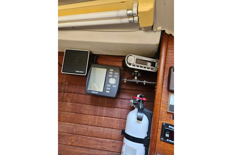 Slide: The Image of Interior of 1986 C & C 29 SL sailboat with navigation equipment and fire extinguisher. - 31