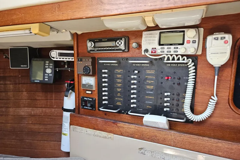 Slide: The Image of Electrical control panel of a 1986 C & C 29 SL sailboat with radio and switches. - 32