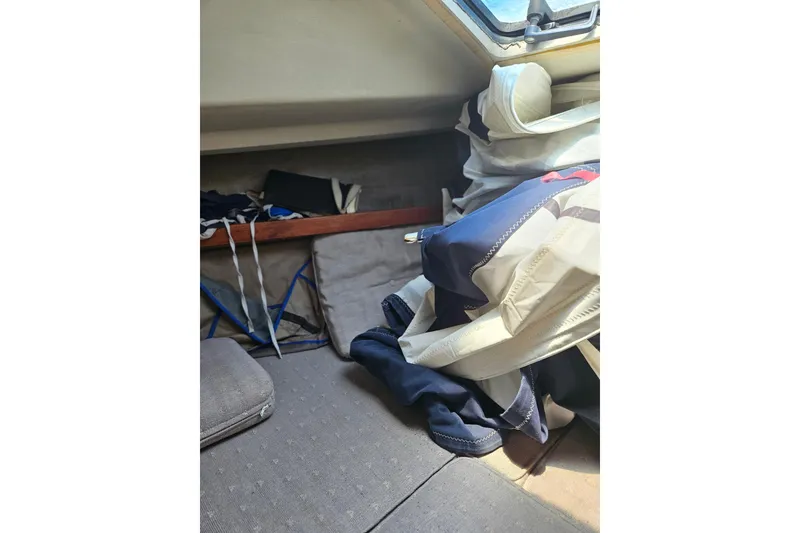 Slide: The Image of Interior of 1986 C & C 29 SL sailboat with cushions and folded sails. - 36