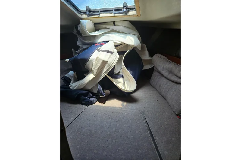 Slide: The Image of Interior of 1986 C & C 29 SL sailboat with sails and cushions. - 38