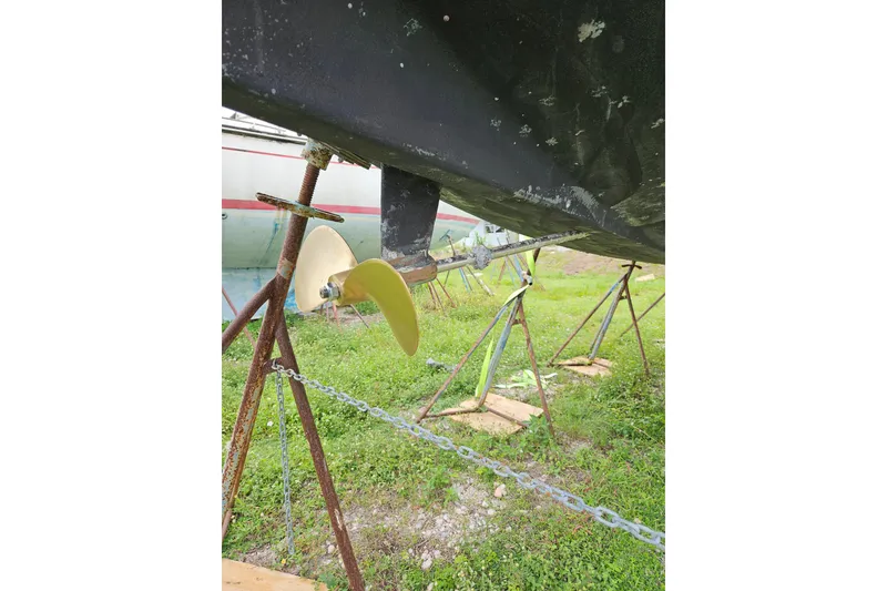 Slide: The Image of Propeller of 1986 CNC 29 SL sailboat on stands, grassy background. - 41