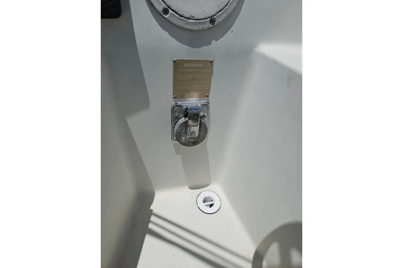Slide: The Image of 1986 C & C 29 SL boat cockpit detail with warning plaque and metal fixture. - 43