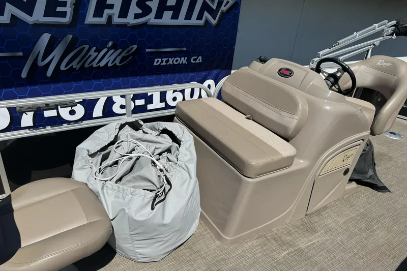 Slide: The Image of 2020 Ranger 200F boat interior with beige seating and storage bag on deck. - 19