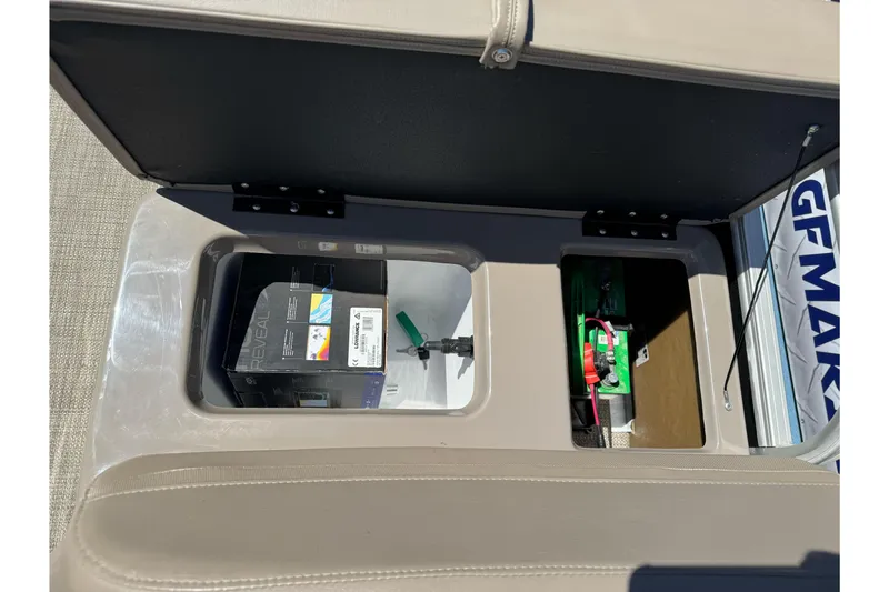 Slide: The Image of Open storage compartment in a 2020 Ranger 200F boat, revealing battery and equipment. - 20
