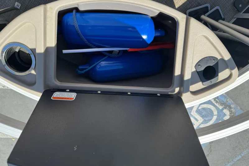 Slide: The Image of Storage compartment in a 2020 Ranger 200F boat with blue fenders and accessories. - 23