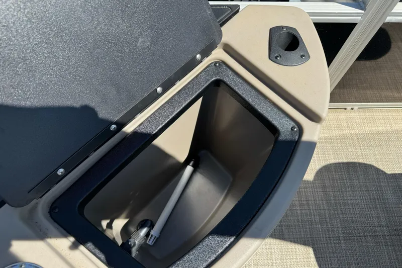 Slide: The Image of Open storage compartment on a 2020 Ranger 200F boat, featuring a beige and black design. - 25
