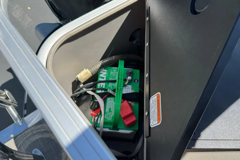 Slide: The Image of Battery compartment of a 2020 Ranger 200F boat, featuring a green marine battery. - 26
