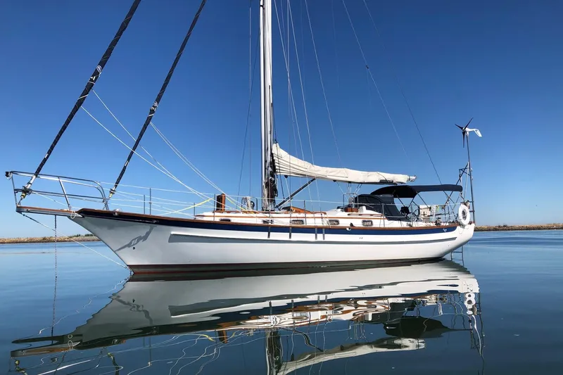 The Image of Sailboat Cabo Rico 38R 1990 on calm water under clear blue sky. - 0