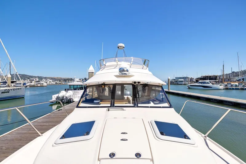Slide: The Image of 2022 Cutwater C-32 CB yacht docked at marina under clear blue sky. - 11