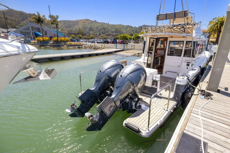 Slide: The Image of 2022 Cutwater C-32 CB boat docked with dual outboard engines in a marina. - 4