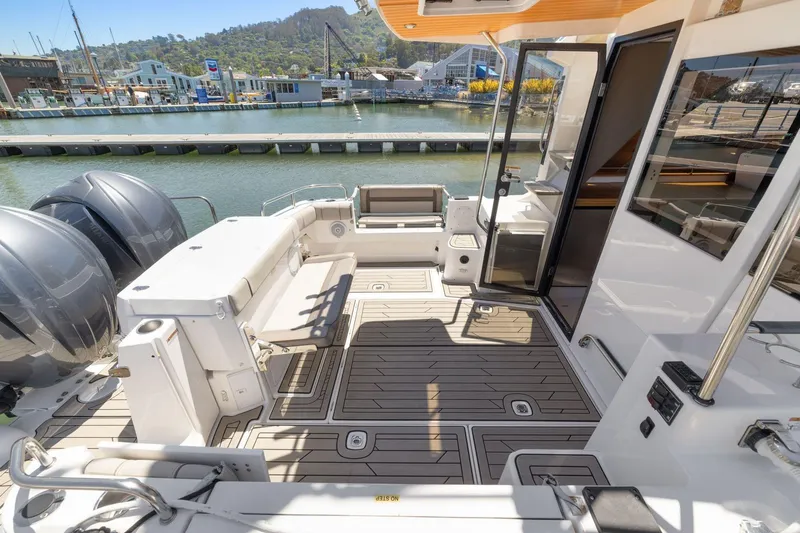 Slide: The Image of 2022 Cutwater C-32 CB boat deck with seating, docked at marina. - 5