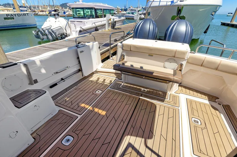 Slide: The Image of 2022 Cutwater C-32 CB boat deck with wood finish, docked at marina. - 6