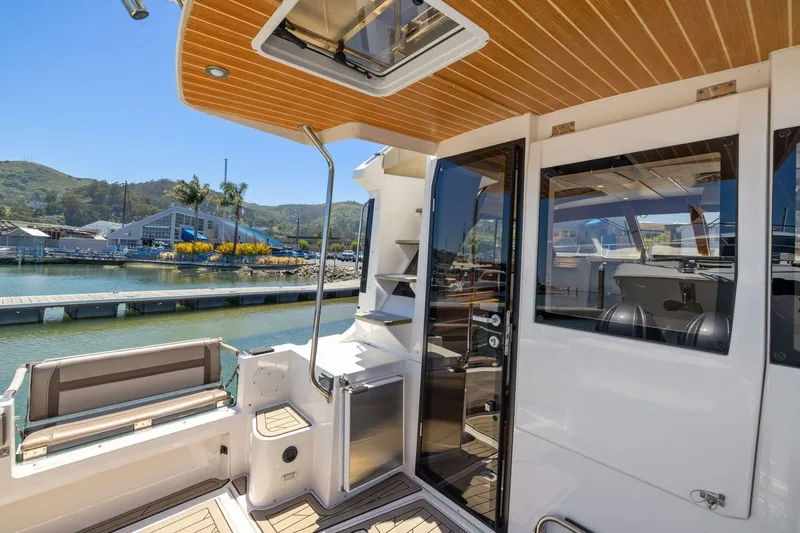 Slide: The Image of 2022 Cutwater C-32 CB boat interior with dockside view, featuring sleek design and modern amenities. - 7