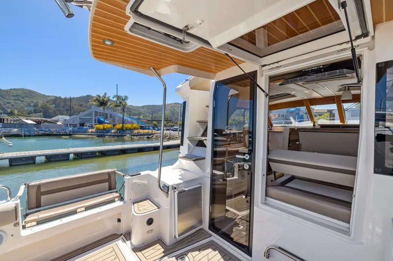 Slide: The Image of 2022 Cutwater C-32 CB boat interior with open seating and marina view. - 8