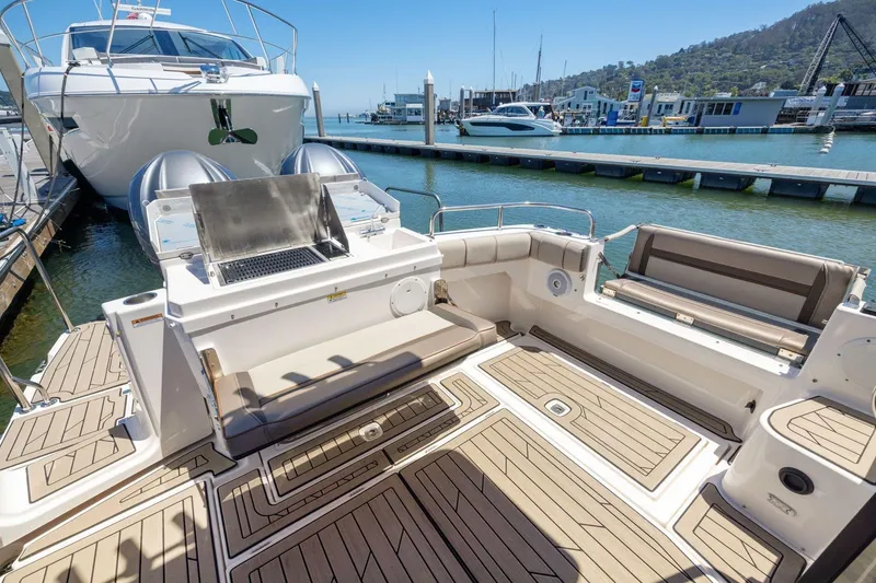 Slide: The Image of 2022 Cutwater C-32 CB boat with spacious deck and seating at marina. - 9