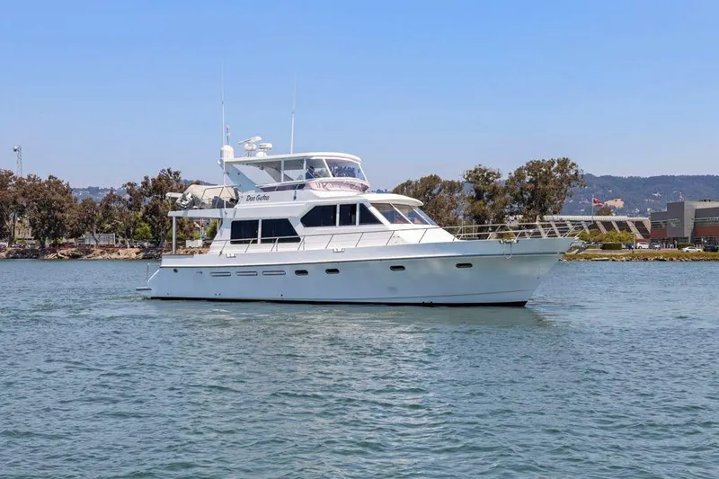 The Image of White 1999 Symbol 55 yacht cruising on a calm waterway with trees in the background. - 0