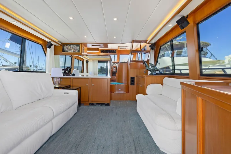 Slide: The Image of Luxurious 1999 Symbol 55 yacht interior with white sofas and wooden cabinetry. - 16