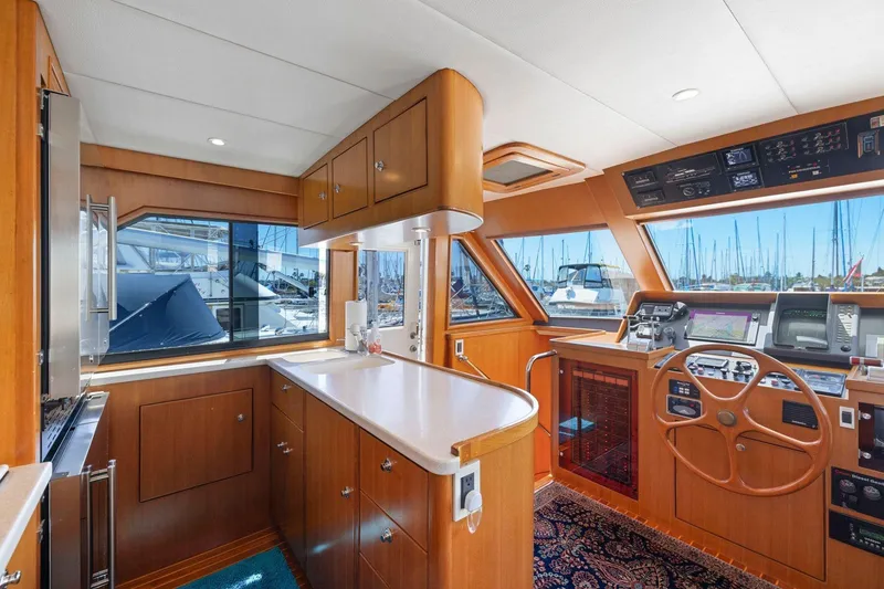Slide: The Image of Luxurious 1999 Symbol 55 yacht interior with wooden cabinetry and modern navigation equipment. - 21