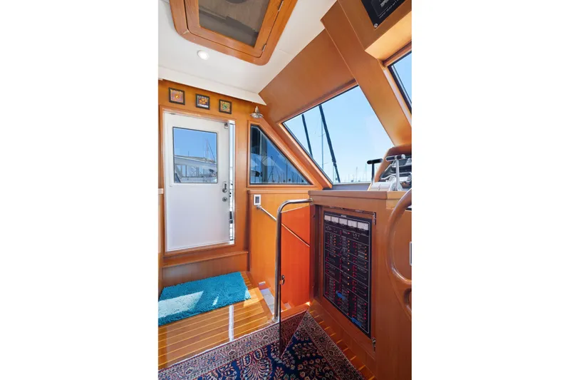 Slide: The Image of Interior of a 1999 Symbol 55 yacht with wooden paneling and control panel. - 25