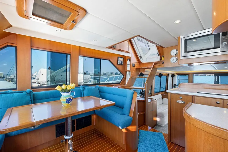 Slide: The Image of Luxurious 1999 Symbol 55 yacht interior with blue seating, wooden accents, and ocean views. - 28