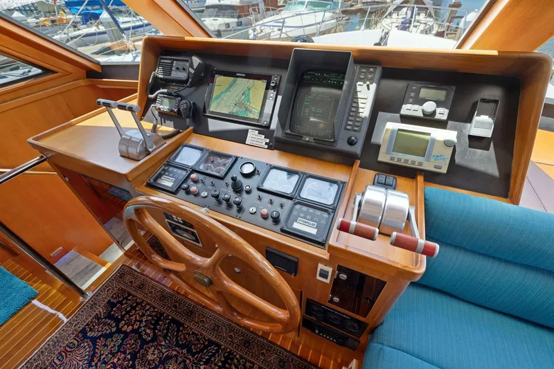 Slide: The Image of Helm of a 1999 Symbol 55 yacht with navigation equipment and wooden steering wheel. - 30