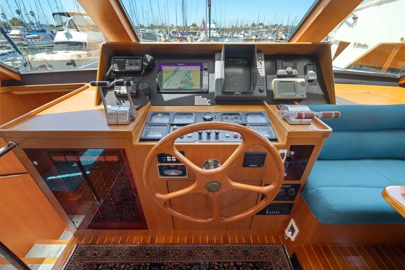 Slide: The Image of Cockpit of a 1999 Symbol 55 yacht with navigation equipment and wooden steering wheel. - 31