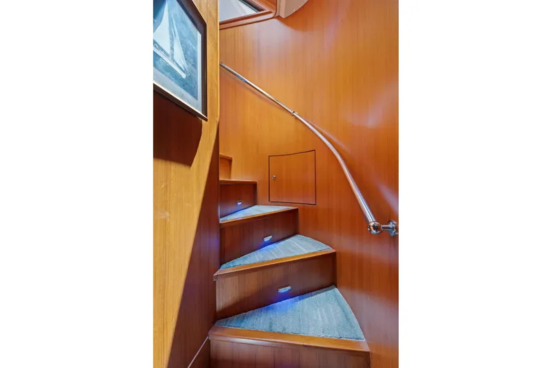 Slide: The Image of Curved wooden staircase with blue-lit steps in a 1999 Symbol 55 yacht interior. - 34