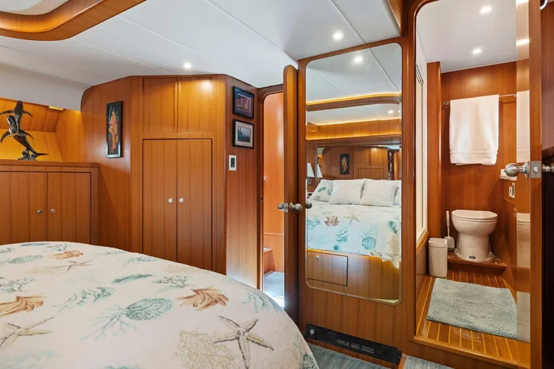 Slide: The Image of Luxurious 1999 Symbol 55 yacht bedroom with ensuite bathroom, featuring elegant wood paneling. - 36