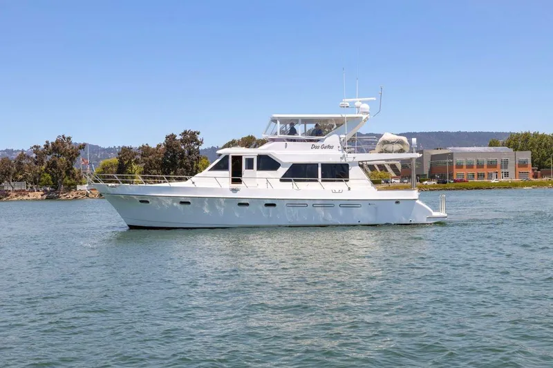 Slide: The Image of White 1999 Symbol 55 yacht cruising on a sunny day near the shoreline. - 4