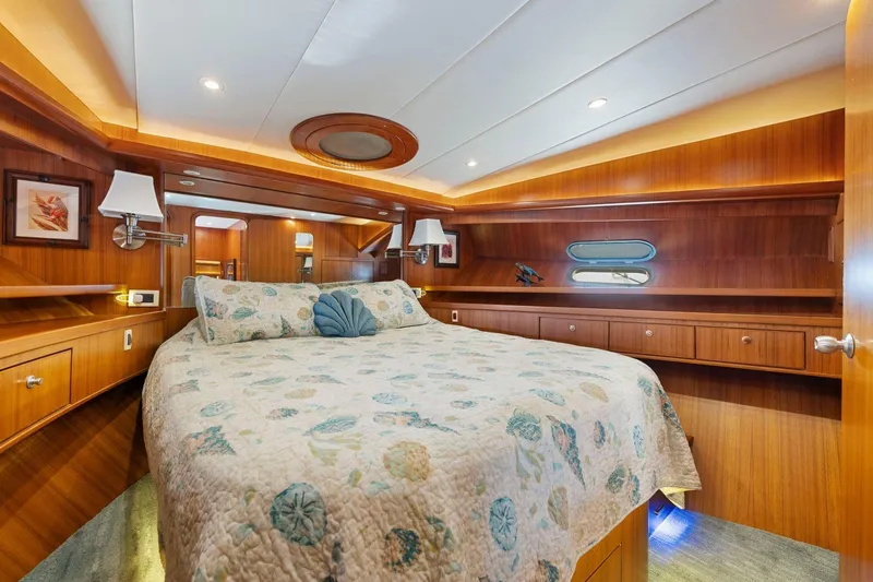 Slide: The Image of Luxurious 1999 Symbol 55 yacht bedroom with wood paneling and elegant bedding. - 43