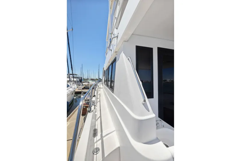 Slide: The Image of Side view of a 1999 Symbol 55 yacht docked at a marina. - 47