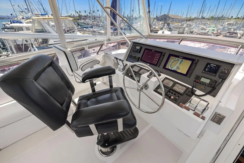 Slide: The Image of Helm of 1999 Symbol 55 yacht with navigation screens and steering wheel. - 58