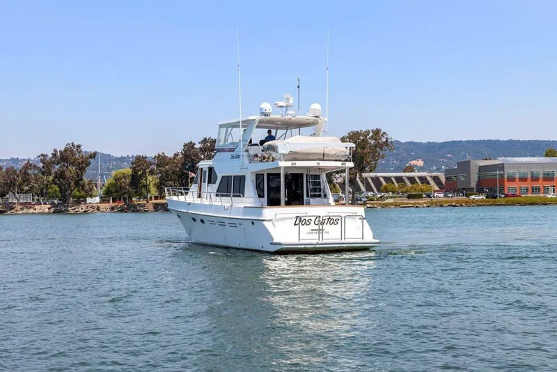 Slide: The Image of A 1999 Symbol 55 yacht cruising on a calm waterway near a scenic shoreline. - 6