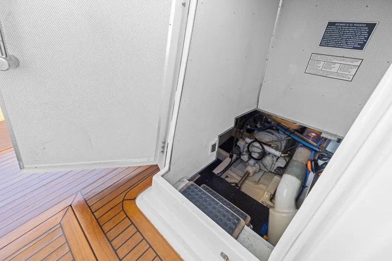 Slide: The Image of Engine compartment of a 1999 Symbol 55 yacht with wooden deck flooring. - 60