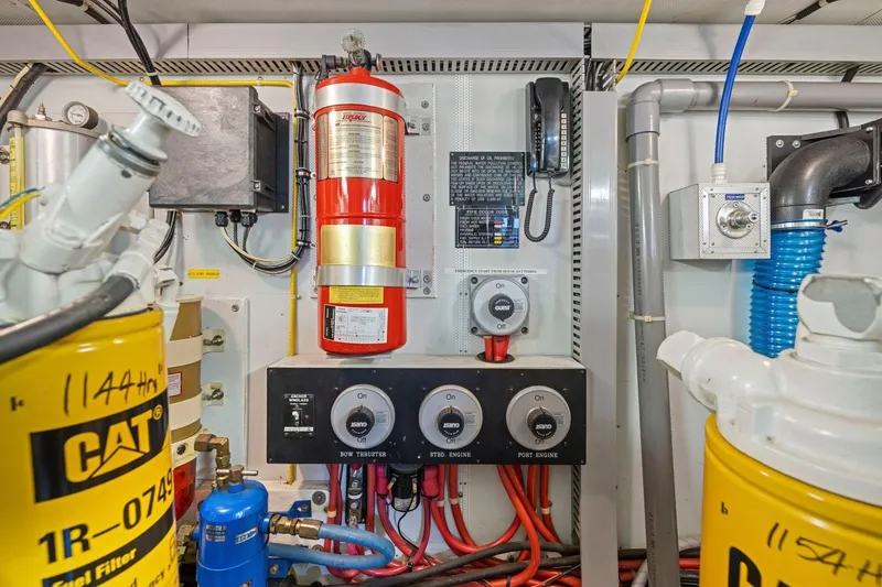 Slide: The Image of Engine room with fire extinguisher, fuel filters, and control panel, Symbol 55, 1999 model. - 65