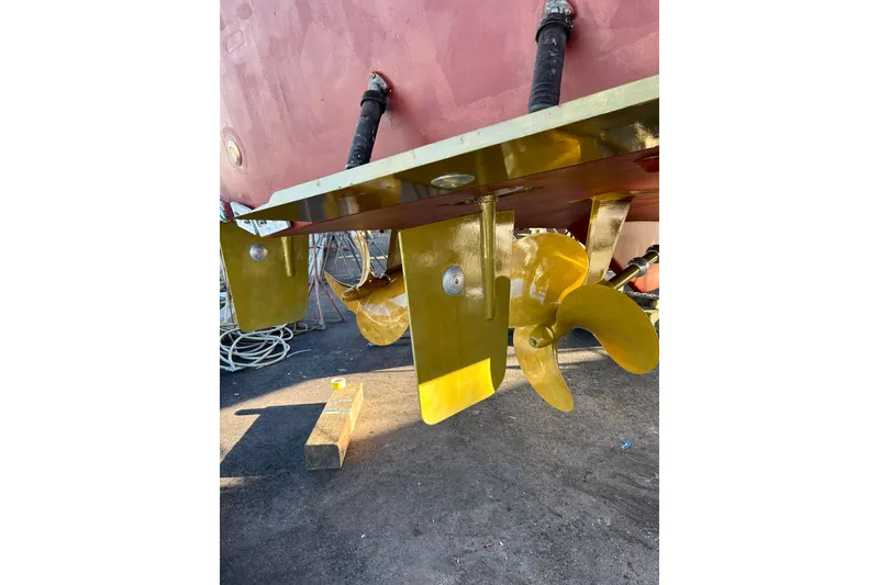 Slide: The Image of Yellow boat propeller and rudder of a 1999 Symbol 58 model, dockside view. - 67