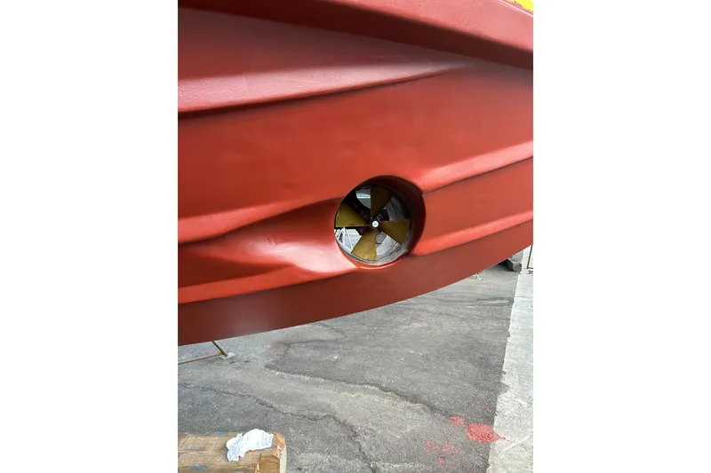 Slide: The Image of Red hull of a 1999 Symbol 58 boat with visible propeller. - 68