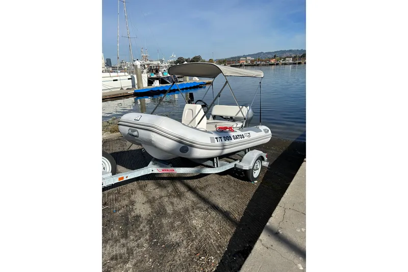 Slide: The Image of Inflatable boat on trailer by waterfront, Symbol 58 model, 1999. - 70