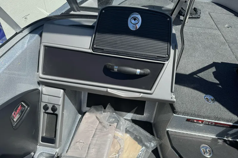 Slide: The Image of 2018 Ranger 1880MS boat interior with dashboard and storage compartments. - 16