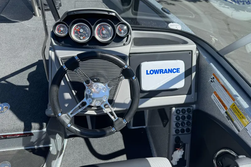 Slide: The Image of 2018 Ranger 1880MS boat dashboard with steering wheel and Lowrance display. - 17