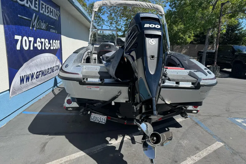 Slide: The Image of 2018 Ranger 1880MS boat with powerful 200HP engine, parked at a marine dealership. - 7
