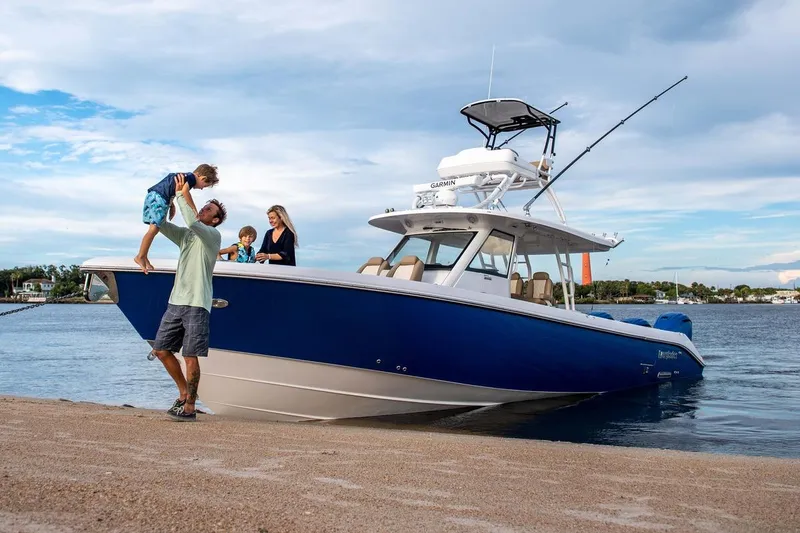 Slide: The Image of Family enjoying a day on the 2025 Everglades 395 Center Console boat by the water. - 1