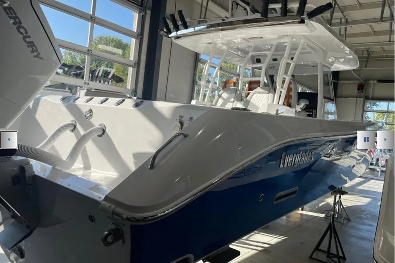 Slide: The Image of 2025 Everglades 395 Center Console boat in showroom, featuring sleek design and modern amenities. - 3