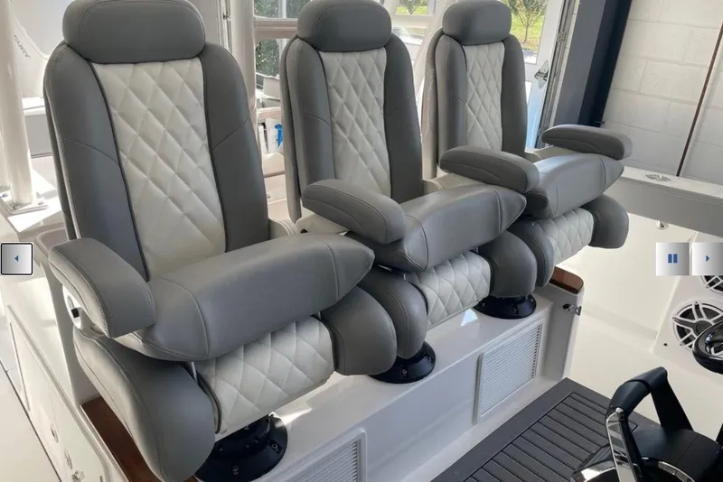 Slide: The Image of Luxurious seating on 2025 Everglades 395 Center Console boat, featuring plush, quilted upholstery. - 6