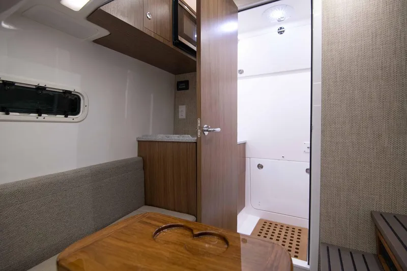 Slide: The Image of Interior cabin of 2025 Everglades 395 Center Console boat with wood accents and seating. - 9