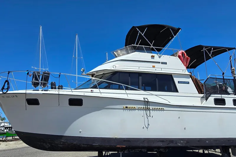 Slide: The Image of 1985 Carver 3207 Aft Cabin Motor Yacht on display under clear blue sky. - 1