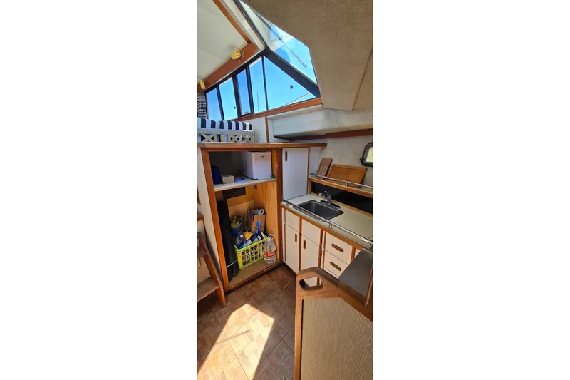 Slide: The Image of Interior of 1985 Carver 3207 Aft Cabin Motor Yacht with kitchenette and storage. - 16