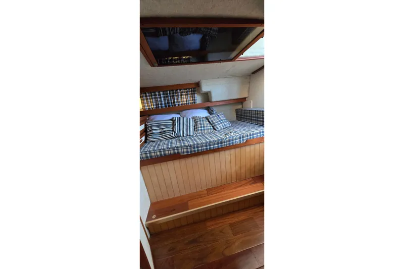Slide: The Image of Cozy cabin interior of 1985 Carver 3207 Aft Cabin Motor Yacht with plaid bedding. - 25