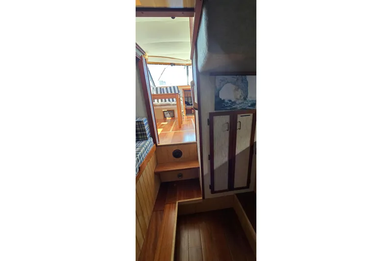 Slide: The Image of Interior view of 1985 Carver 3207 Aft Cabin Motor Yacht with wooden flooring and seating. - 28