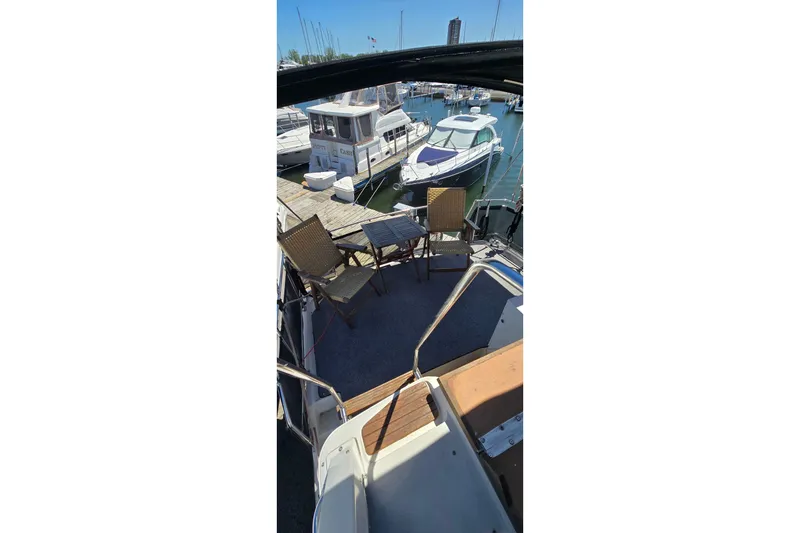 Slide: The Image of 1985 Carver 3207 Aft Cabin Motor Yacht docked with outdoor seating area. - 4